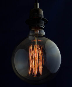 Edison G125 Globe incandescent light bulb on blue Background