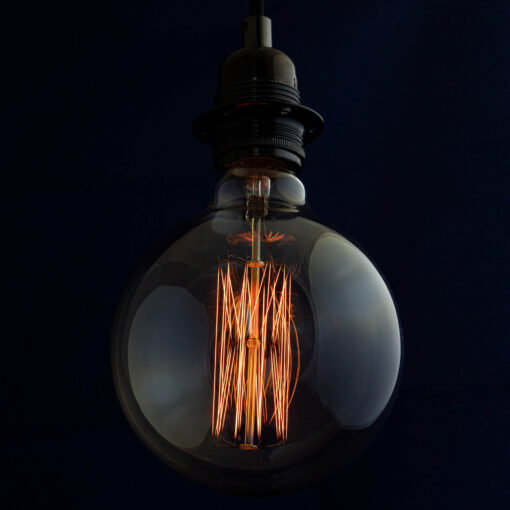 Edison G125 Globe incandescent light bulb on blue Background