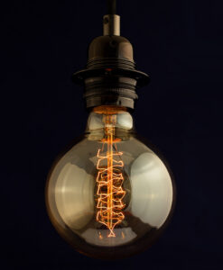 Edison G125 Globe Spiral incandescent light bulb on blue Background
