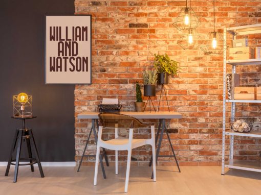 cluster of Cage lamp hanging from Ceiling in a rustic Brick wall interior study room