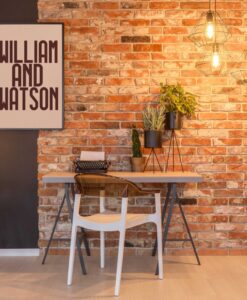 cluster of Cage lamp hanging from Ceiling in a rustic Brick wall interior study room