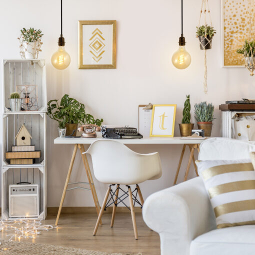 Globe spiral edison bulb hanging from the ceiling in a home office bedroom